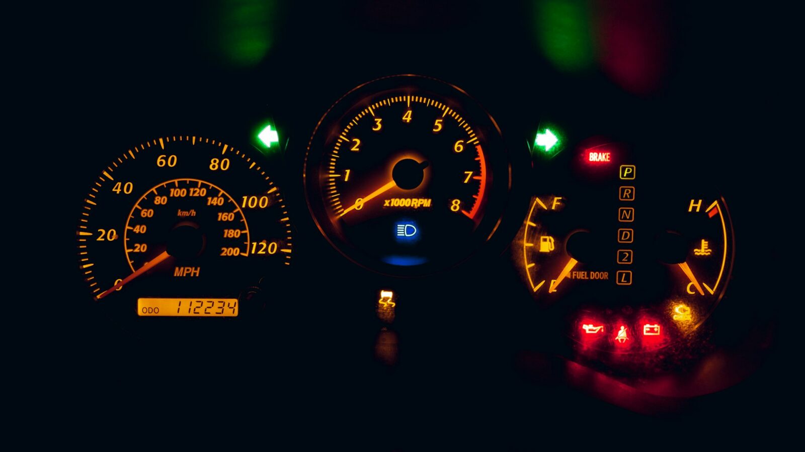 Instrument cluster at night with warning lights lit