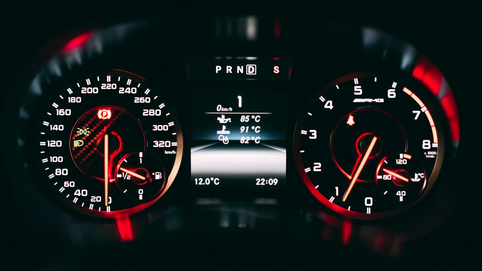 Illuminated instrument cluster with red-lit gauges