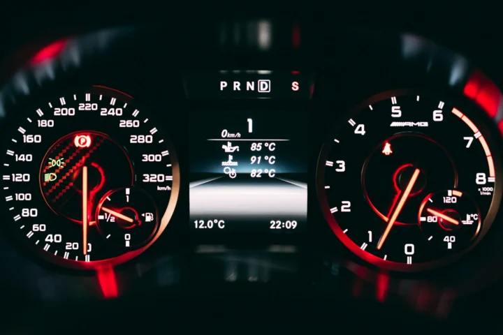 Illuminated instrument cluster with red-lit gauges